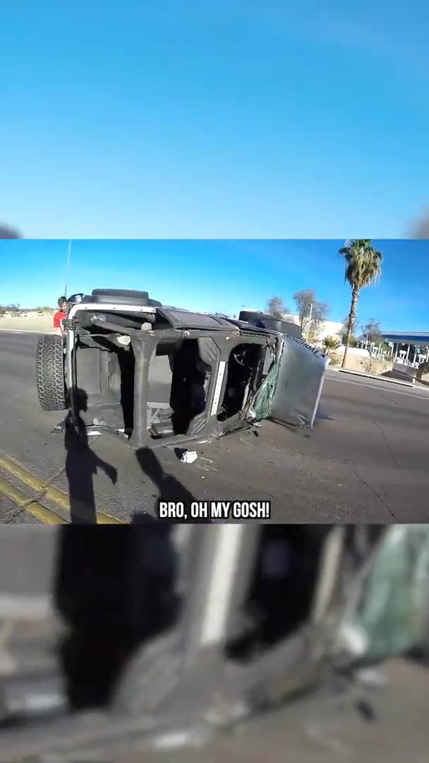Rollover crash caught on motorcycle helmet camera as the vehicle tumbles across the road
